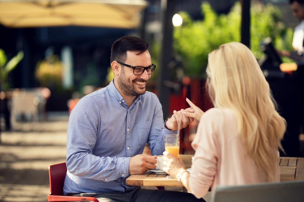 A couple talking over coffee