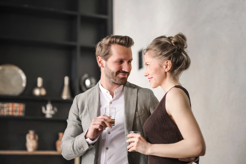 A couple talking at a social gathering
